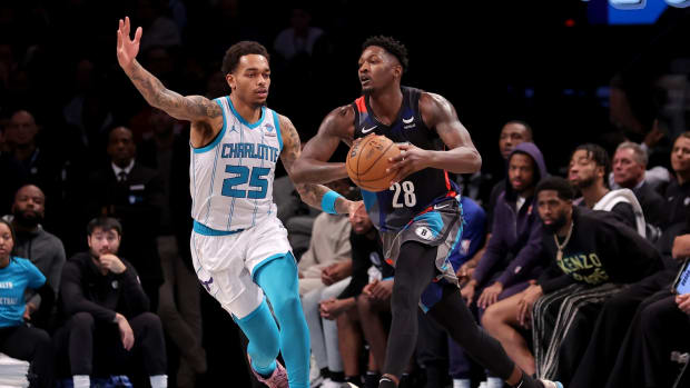 Brooklyn Nets forward Dorian Finney-Smith (28) looks to pass the ball against Charlotte Hornets forward P.J. Washington (25) during the fourth quarter at Barclays Center.